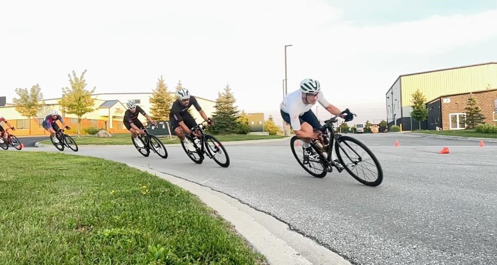 Criterium racers leaning through a corner in Uxbridge